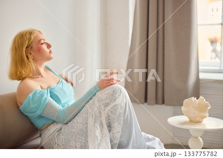 contemplative blonde woman indoors, elegant woman in pastel outfit contemplating inside environment contemplative blonde woman indoors, elegant woman in pastel outfit contemplating inside environment 133775782