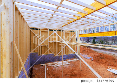 Construction of new building with wooden framing foundation work taking place 133776195