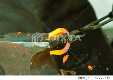 Hammering glowing steel - to strike while the iron is hot. Hammering glowing steel - to strike while the iron is hot. 133777619