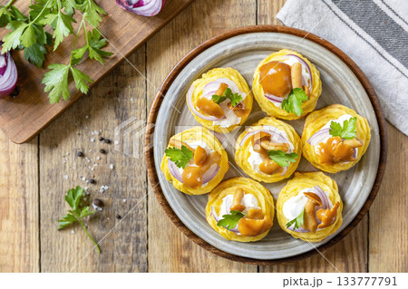 Potato tartlets filled with cottage cheese and marinated mushrooms on a rustic background. Top view. 133777791