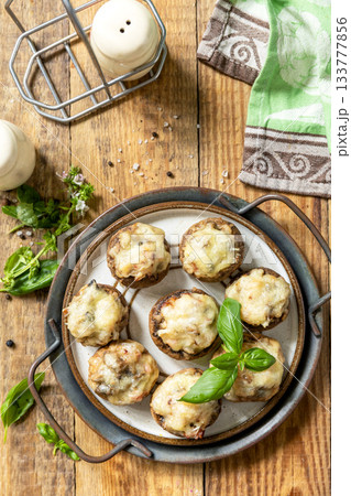 Stuffed mushrooms baked with cheese on rustic background. Top view. Stuffed mushrooms baked with cheese on rustic background. Top view. 133777856