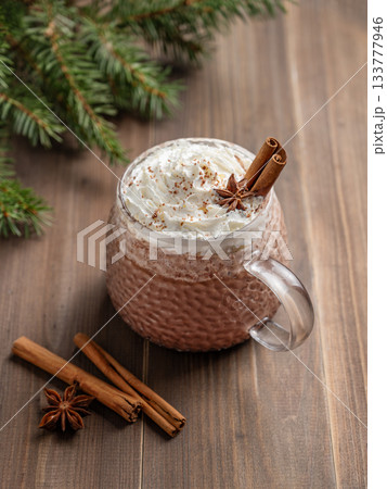 Hot chocolate with whipped cream in a cup on a dark wooden background Hot chocolate with whipped cream in a cup on a dark wooden background 133777946