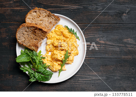 Scrambled eggs with greens for breakfast Scrambled eggs with greens for breakfast 133778511