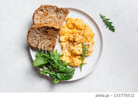 Scrambled eggs with greens for healthy keto breakfast Scrambled eggs with greens for healthy keto breakfast 133778512