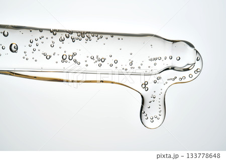 Cosmetic pipette dispensing serum with bubbles macro Cosmetic pipette dispensing serum with bubbles macro 133778648