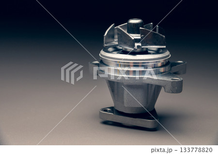 Engine cooling pump, engine coolant pump for a passenger car on a black gradient background. Selective focus 133778820