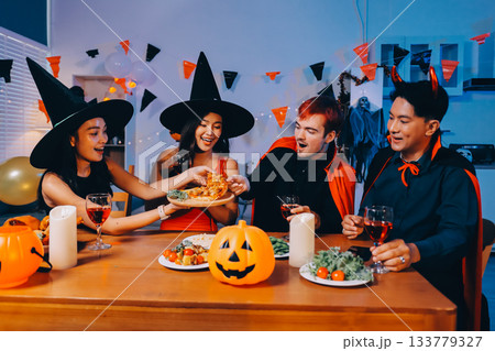 Joyful office Halloween party with coworkers in costumes, celebrating with drinks and laughter, fostering teamwork and festive spirit Joyful office Halloween party with coworkers in costumes, celebrating with drinks and laughter, fostering teamwork and festive spirit 133779327