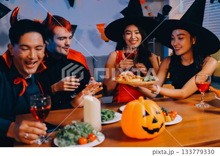 Joyful office Halloween party with coworkers in costumes, celebrating with drinks and laughter, fostering teamwork and festive spirit Joyful office Halloween party with coworkers in costumes, celebrating with drinks and laughter, fostering teamwork and festive spirit 133779330