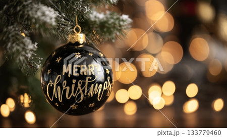 Minimal festive ornament on frosty evergreen tree, neutral tones and glowing lights perfect for modern holiday greeting cards. 133779460