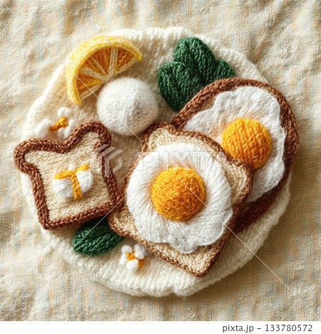 A charming handmade knitted breakfast plate with eggs, toast, greens, and lemon, designed in soft yarn textures.. High quality photo 133780572