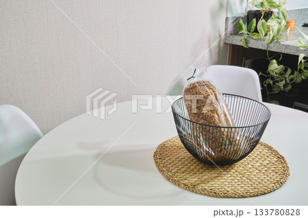 Whole grain bread in basket on modern kitchen table 133780828