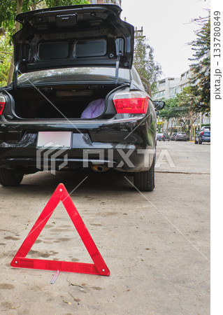 Car breakdown with warning triangle on road 133780849