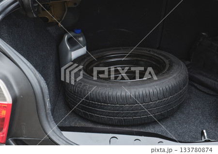 Car trunk with spare tire and fluid container Car trunk with spare tire and fluid container 133780874
