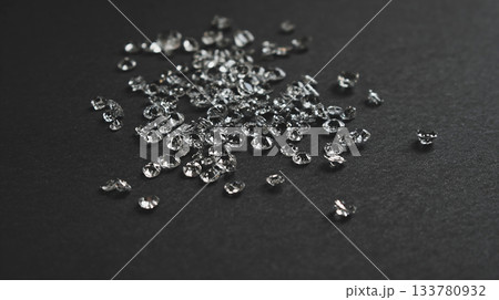photo of white crystals scattered on black matte plane, can be used as poster or banner photo of white crystals scattered on black matte plane, can be used as poster or banner 133780932
