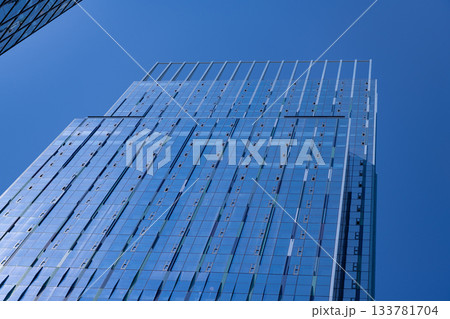 Glass skyscraper. City architecture. Architecture of office building. Skyscraper architecture. Business skyscraper building. Architectural building business area. Elegant glass office Glass skyscraper. City architecture. Architecture of office building. Skyscraper architecture. Business skyscraper building. Architectural building business area. Elegant glass office 133781704