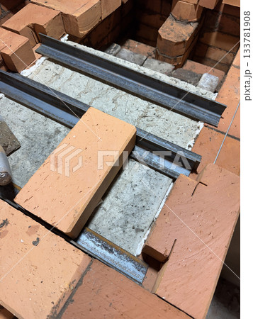 Installation of the heating stove ceiling. With concrete slabs and bricks on metal angles. Construction of a heating stove. 133781908