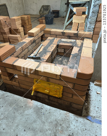 Construction of a heating stove. Brickwork of the stove core with its caps. 133781925
