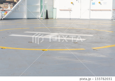 Empty helipad marked with a large H on the deck of a ship. Clean lines, safety markings and soft daylight emphasize the functional design and maritime safety environment Empty helipad marked with a large H on the deck of a ship. Clean lines, safety markings and soft daylight emphasize the functional design and maritime safety environment 133782031