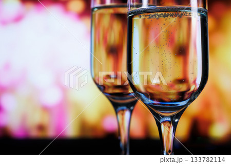 Two glasses of champagne against a backdrop of fireworks 133782114