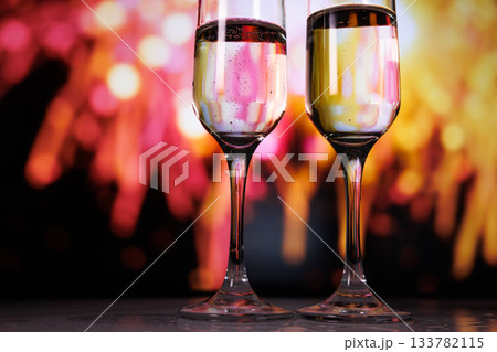 Two glasses of champagne against a backdrop of fireworks 133782115