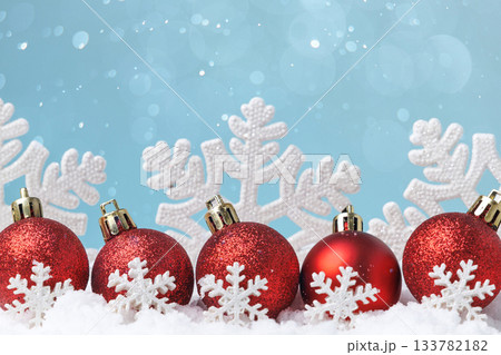 Red Christmas baubles with snowflake pattern on snow, copy space Red Christmas baubles with snowflake pattern on snow, copy space 133782182