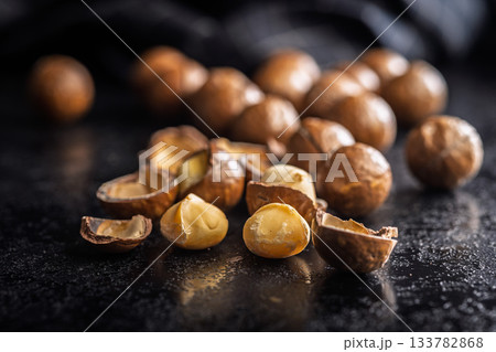 Tasty macadamia nuts on black table. 133782868