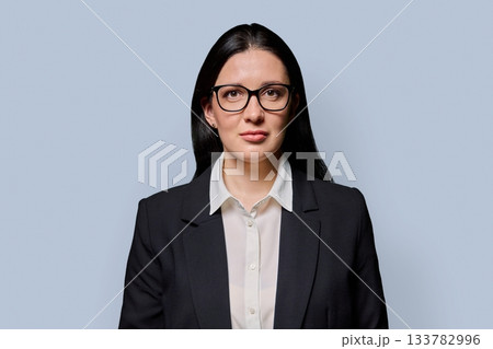 Portrait of serious middle-aged businesswoman in black jacket on light studio background Portrait of serious middle-aged businesswoman in black jacket on light studio background 133782996