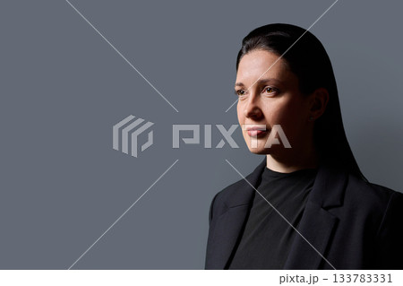 Profile headshot portrait of beautiful 40 years old woman in black wear on gray background Profile headshot portrait of beautiful 40 years old woman in black wear on gray background 133783331