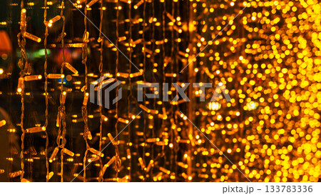 garland of light bulbs in a window display for Christmas, decorating shops and retail outlets for the beloved winter holiday garland of light bulbs in a window display for Christmas, decorating shops and retail outlets for the beloved winter holiday 133783336