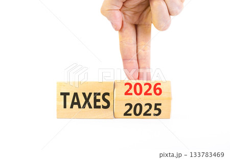 2026 taxes new year symbol. Concept words 2026 taxes on beautiful wooden blocks. Beautiful white paper background. Businessman's hand. Business and 2026 taxes new year concept. Copy space. 2026 taxes new year symbol. Concept words 2026 taxes on beautiful wooden blocks. Beautiful white paper background. Businessman's hand. Business and 2026 taxes new year concept. Copy space. 133783469