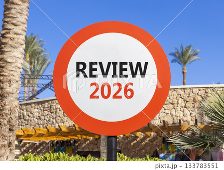 Review 2026 symbol. Concept words Review 2026 on beautiful white and red road sign. Beautiful palm trees palm-trees and blue sky background. Business and review 2026 concept. Copy space. 133783551