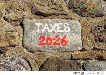 Taxes 2026 new year symbol. Concept words Taxes 2026 on beautiful grey stone on stone wall. Beautiful stone wall background. Business and taxes 2026 new year concept. Copy space. 133783552