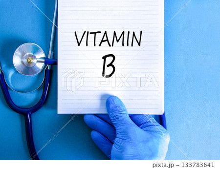 Vitamin B symbol. Concept words Vitamin B on beautiful white note. Doctor's hand in blue medical glove. Stethoscope. Beautiful blue background. Medical healthy lifestyle Vitamin B concept. Vitamin B symbol. Concept words Vitamin B on beautiful white note. Doctor's hand in blue medical glove. Stethoscope. Beautiful blue background. Medical healthy lifestyle Vitamin B concept. 133783641