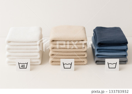 Folded colored towels with care icons. 133783932
