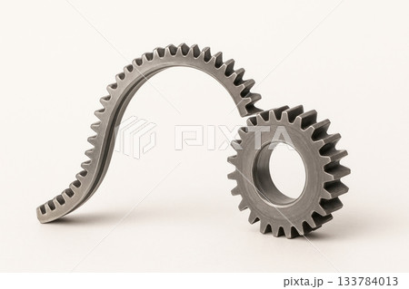 Curved and straight metal gears as a symbol of a non-standard solution. Space for text. Curved and straight metal gears as a symbol of a non-standard solution. Space for text. 133784013