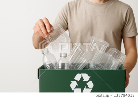 A man sorts plastic waste for recycling. A man sorts plastic waste for recycling. 133784015