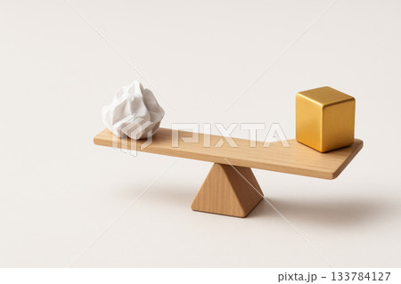 A wooden swing with a white lump and a golden cube, symbolizing balance. Space for text. 133784127