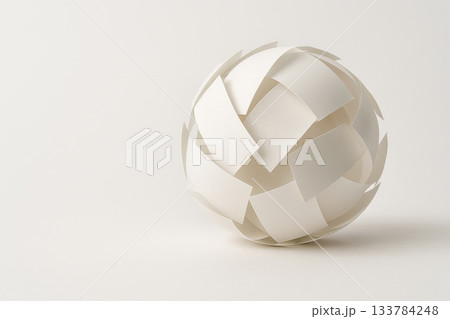 A ball assembled from white paper sheets. Space for text. A ball assembled from white paper sheets. Space for text. 133784248