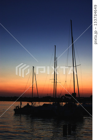sunset sailing yacht sailboat moored to shore in port three masts 133784649