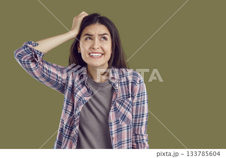 Portrait of funny confused expression young woman who made mistake and thinks how to solve problem. 133785604