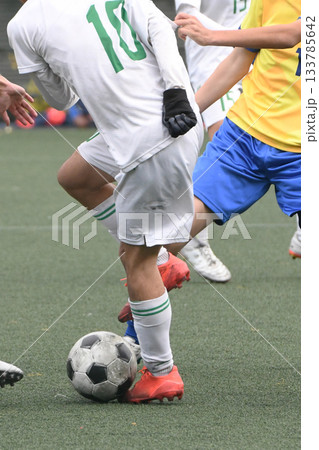 ドリブルするサッカー選手 133785642