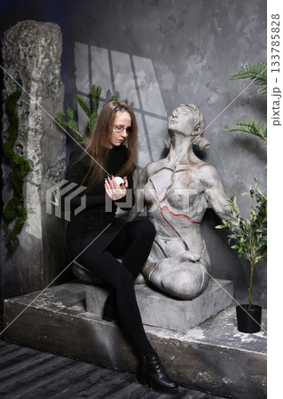 Gallery curator examines artifact, Woman reviews relic with care 133785828