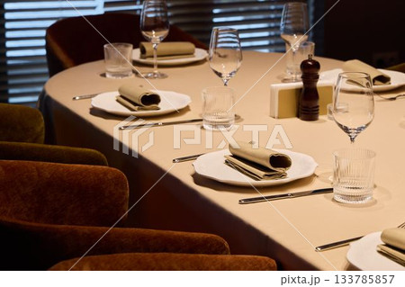 Exquisite table arrangement with delicate napkins and ambient lighting perfect for celebrations Exquisite table arrangement with delicate napkins and ambient lighting perfect for celebrations 133785857