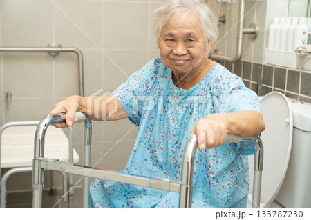 Asian elderly woman patient use walker and toilet bathroom handle security in nursing hospital, healthy strong medical. 133787230
