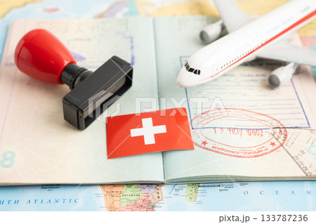 Approved Stamp visa and passport with Switzerland flag document to immigration at airport in country. Approved Stamp visa and passport with Switzerland flag document to immigration at airport in country. 133787236