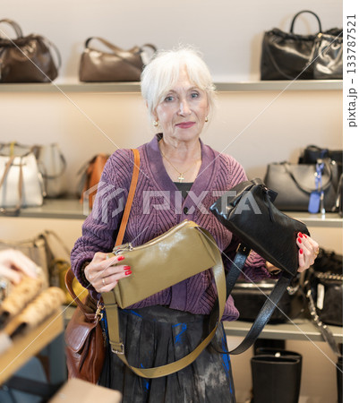 Senior woman at trading floor pick out and buying handbag. Senior woman at trading floor pick out and buying handbag. 133787521
