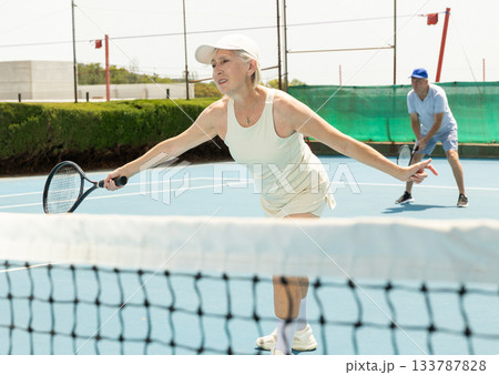 Senior woman plays tennis Senior woman plays tennis 133787828