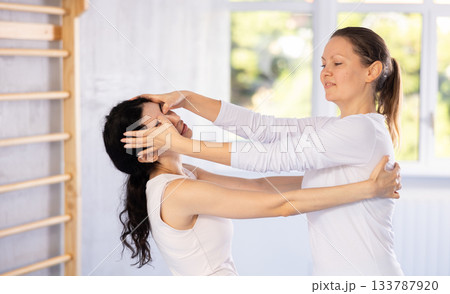 Two women training self-defense techniques in studio 133787920