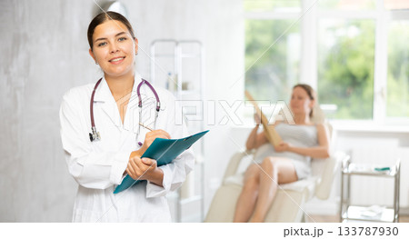 Young female doctor making notes in medical room Young female doctor making notes in medical room 133787930
