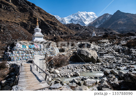 Tibetan Buddhist stupa on the way to Kyangjin Kharka village in Langtang National park in Nepal. The Langtang Valley is mainly inhabited by the Tamang people they mainly follow Tibetan Buddhism. 133788090